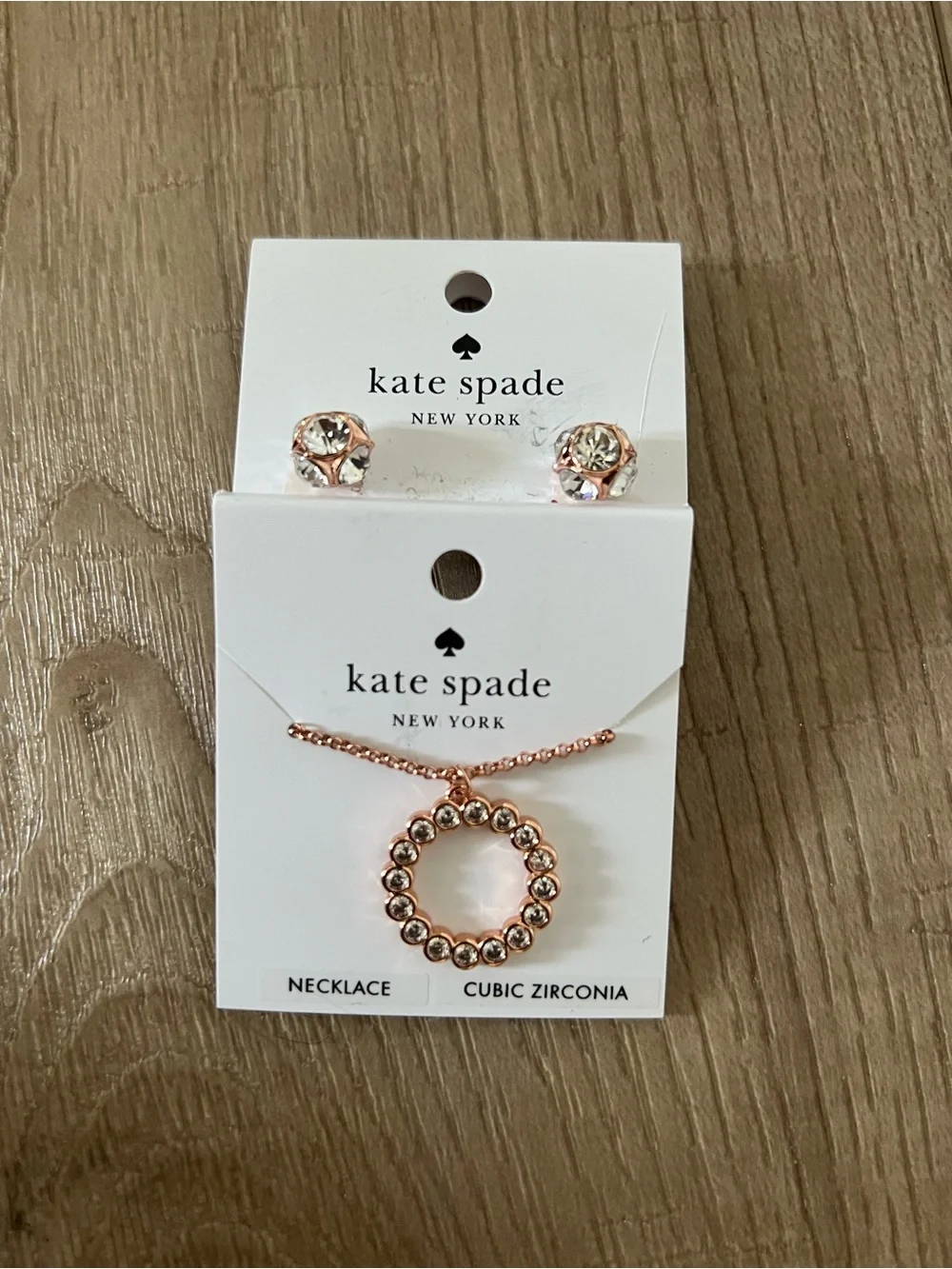 Kate Spade rose gold circle pendant necklace with clear stones and stud earrings